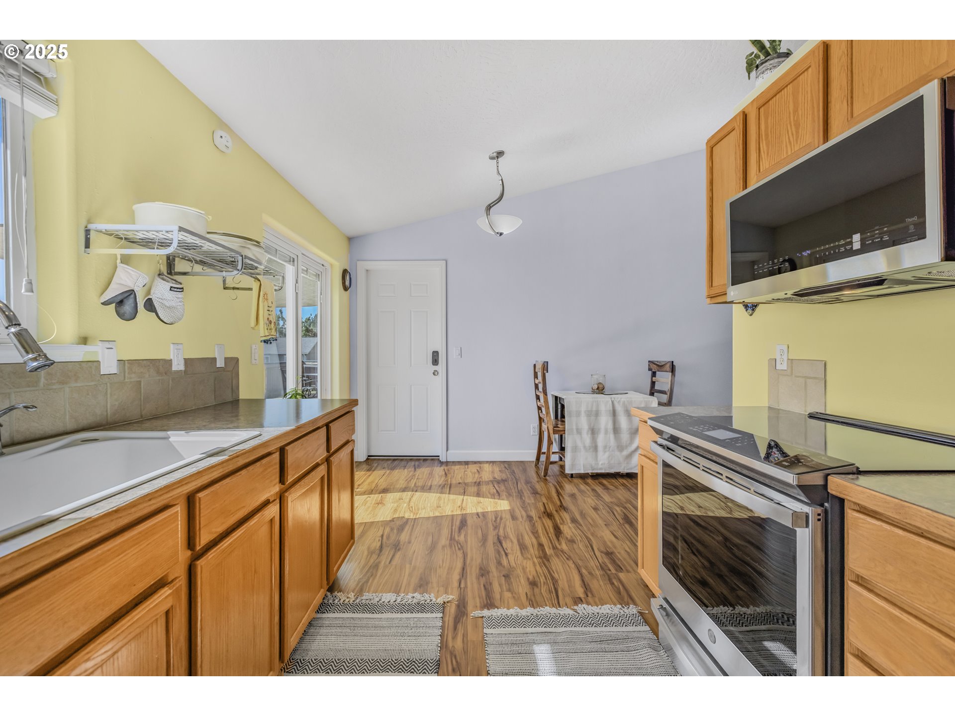 1580 South 60th Street Springfield, OR 97478 - Photo 17 of 36 a view of a kitchen with a sink and microwave