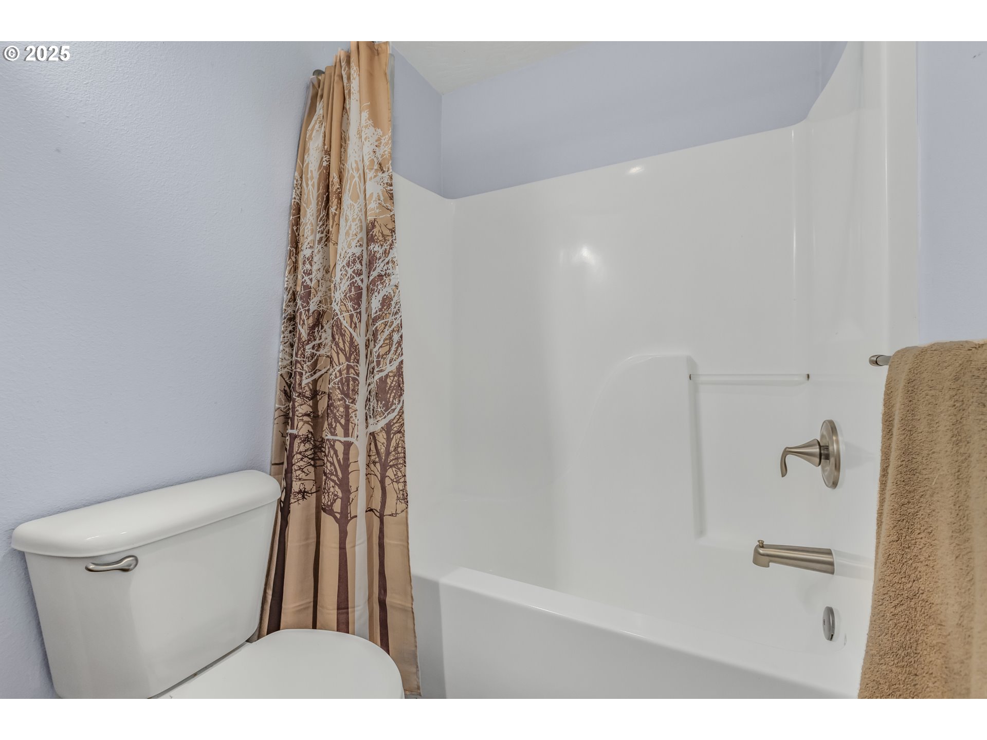 1580 South 60th Street Springfield, OR 97478 - Photo 23 of 36 a bathroom with a shower curtain and a toilet