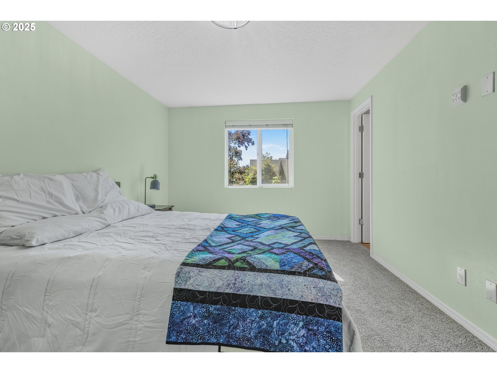 1580 South 60th Street Springfield, OR 97478 - Photo 25 of 36 a bedroom with a bed and a painting on the wall