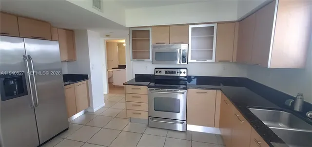 a kitchen with a stove sink and refrigerator