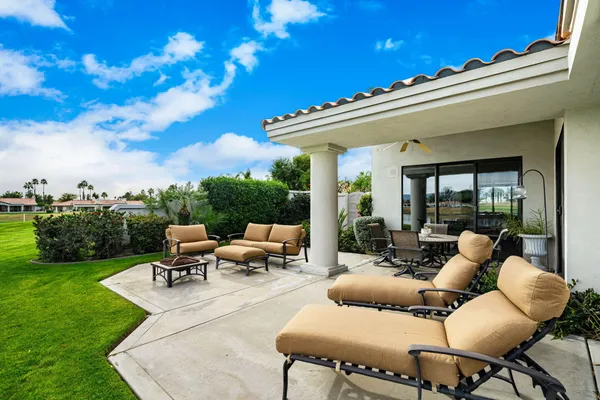 a view of a patio with table and chairs and potted plants