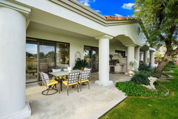 a view of a backyard with sitting area