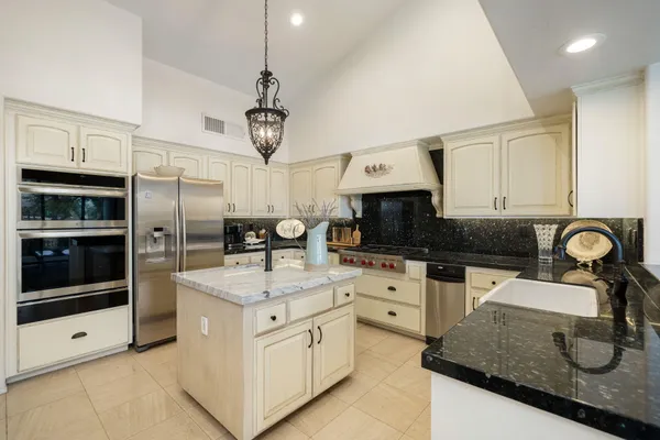 a kitchen with cabinets and stainless steel appliances