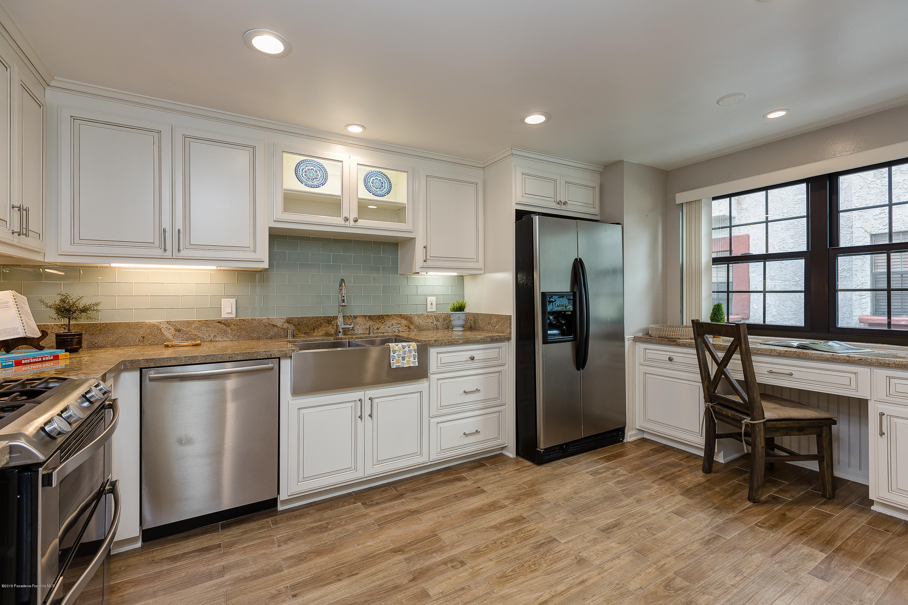 124 Monterey Road, Unit 218 South Pasadena, CA 91030 - Photo 2 of 20 a kitchen with a refrigerator and a stove top oven