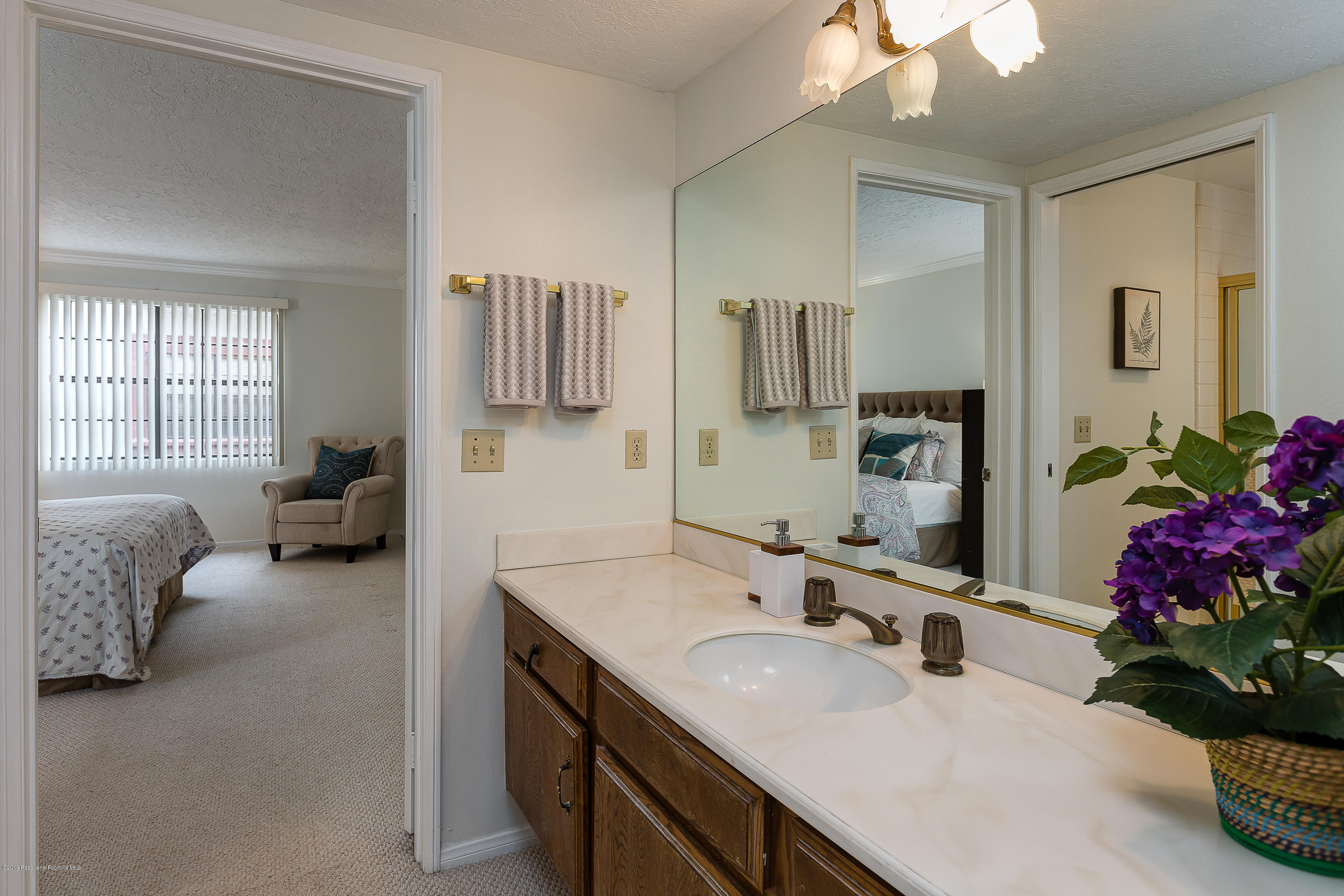 124 Monterey Road, Unit 218 South Pasadena, CA 91030 - Photo 12 of 20 a en suite bathroom with a double vanity sink and a mirror