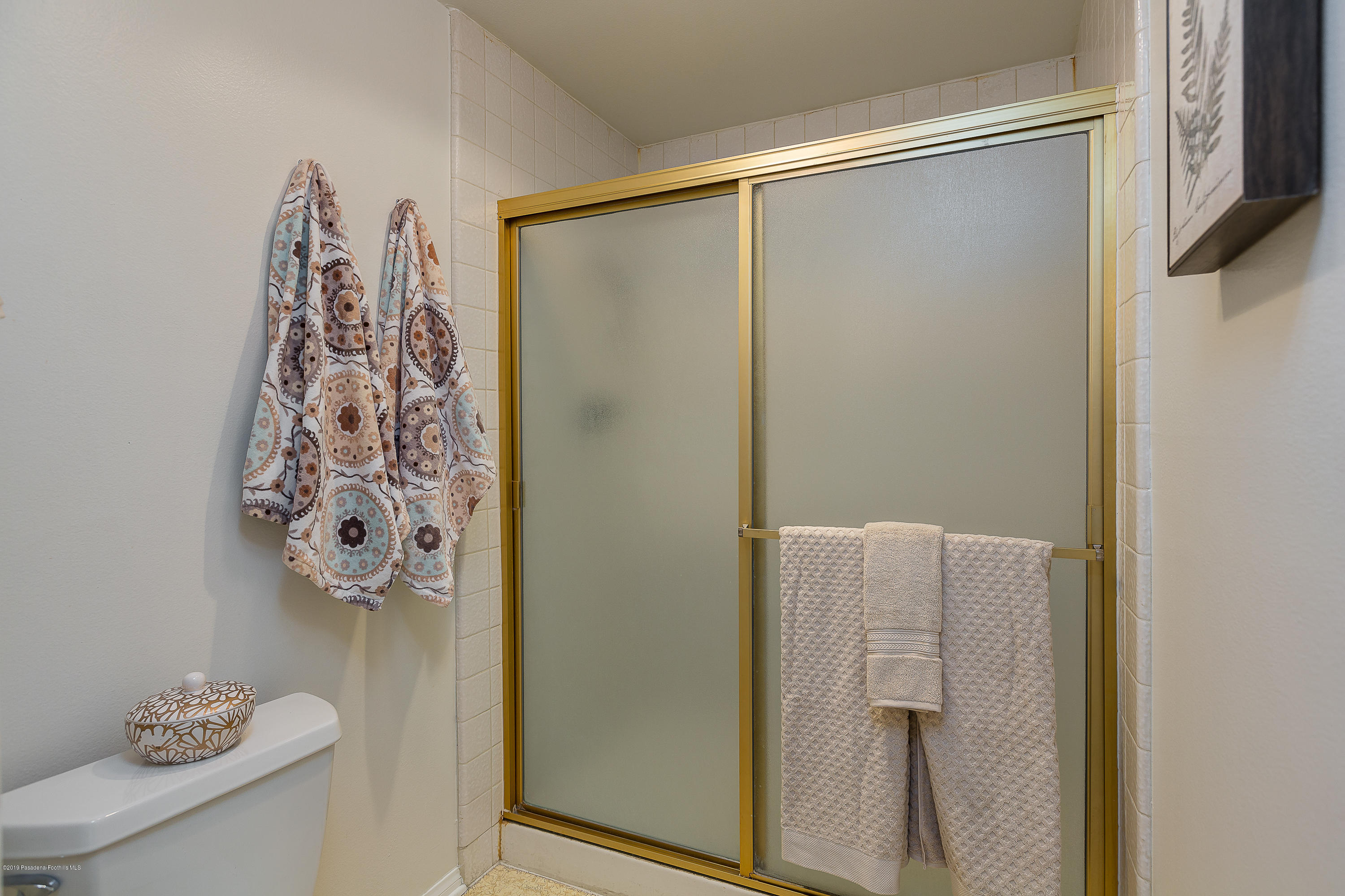124 Monterey Road, Unit 218 South Pasadena, CA 91030 - Photo 13 of 20 a bathroom with a shower curtain and a window