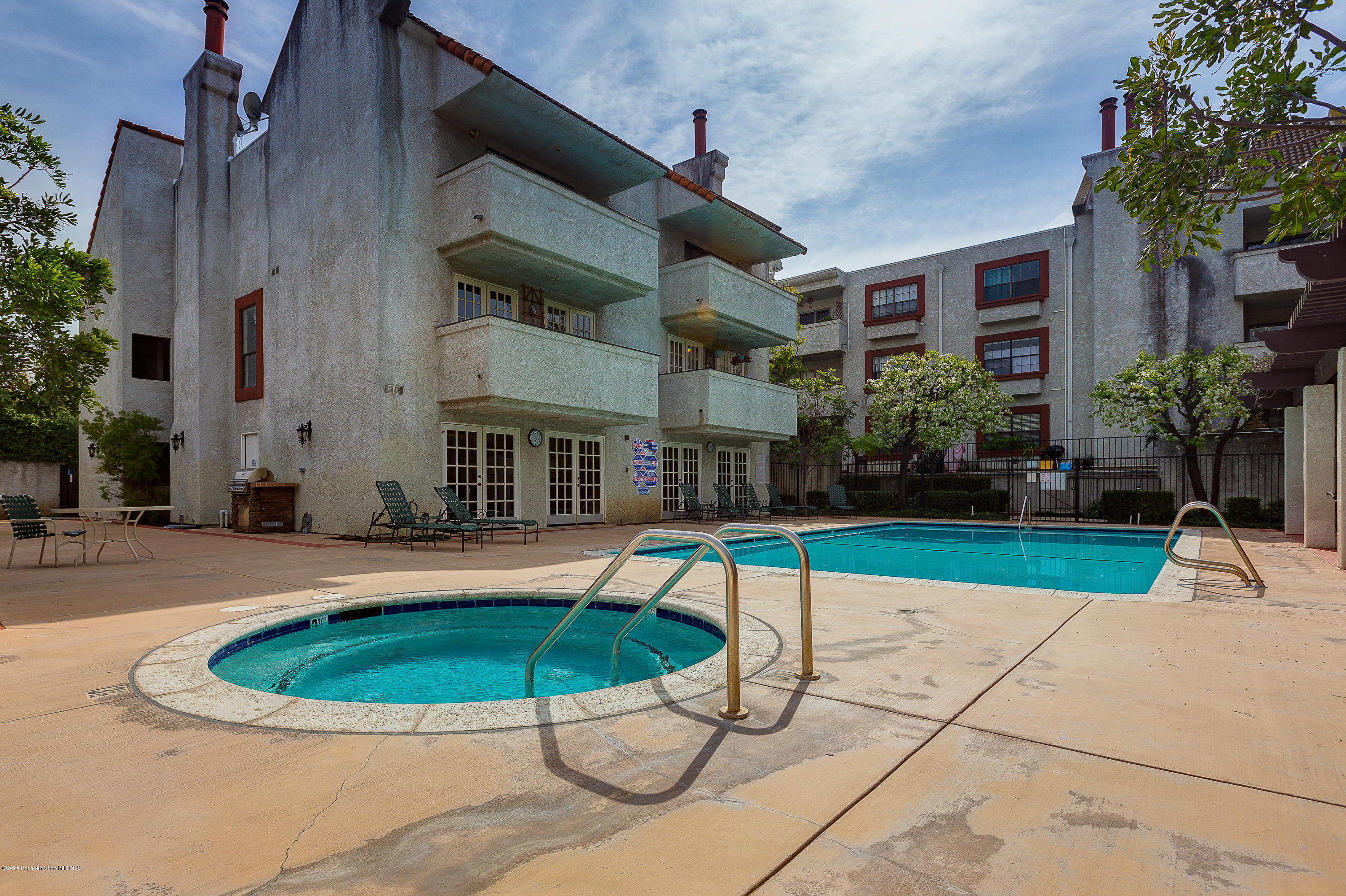124 Monterey Road, Unit 218 South Pasadena, CA 91030 - Photo 20 of 20 a house with a swimming pool and yard