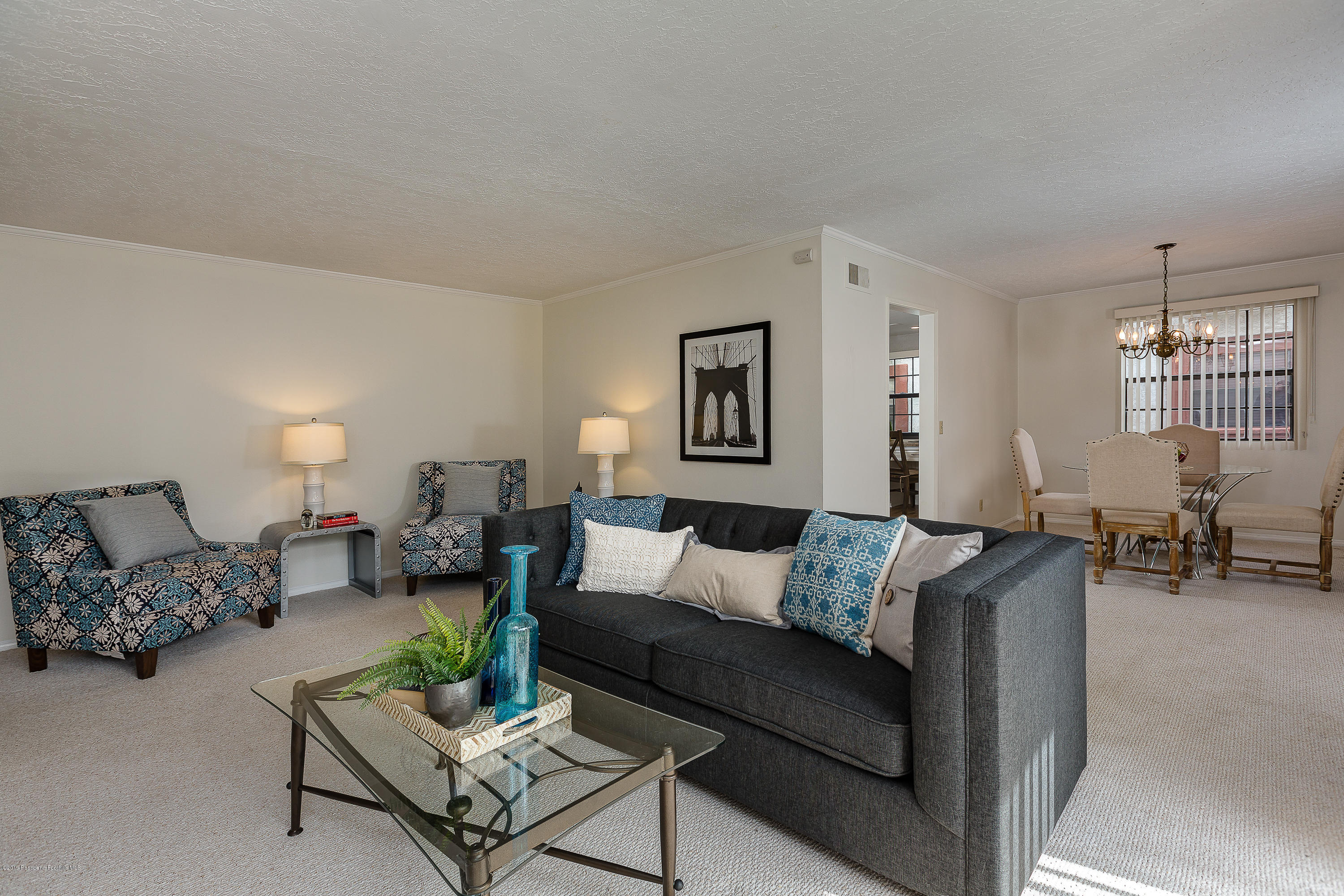 124 Monterey Road, Unit 218 South Pasadena, CA 91030 - Photo 6 of 20 a living room with furniture and a table