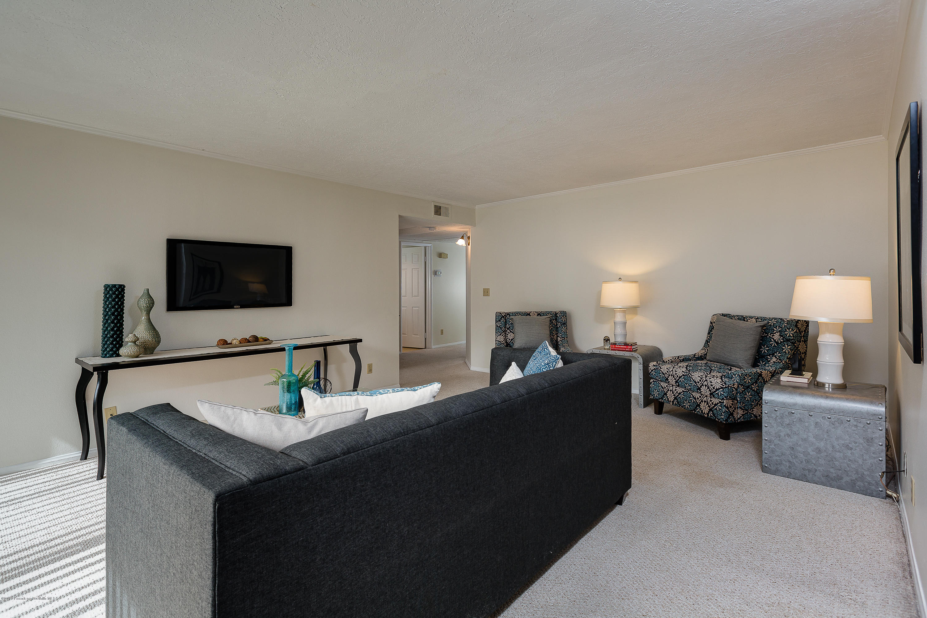 124 Monterey Road, Unit 218 South Pasadena, CA 91030 - Photo 7 of 20 a living room with furniture and a flat screen tv