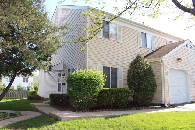 461 Minnesota Circle Carol Stream, IL 60188 - Photo 1 of 15 a front view of a house with a yard and garage