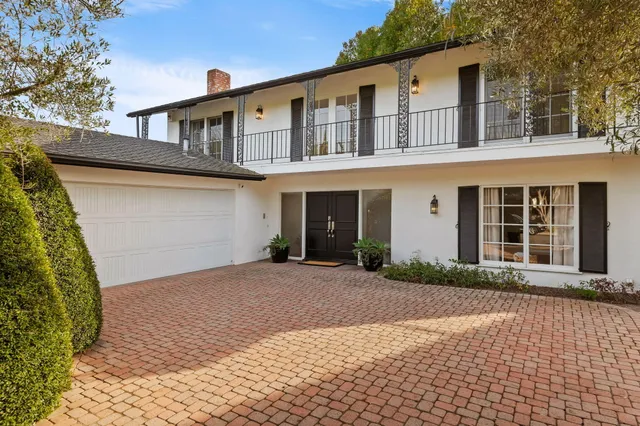 a front view of a house with a yard and a garage