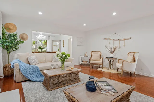 a living room with furniture and a chandelier