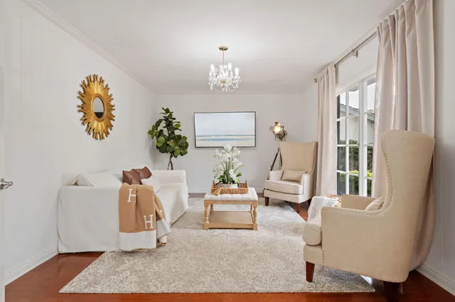 a living room with furniture a fireplace and a large window
