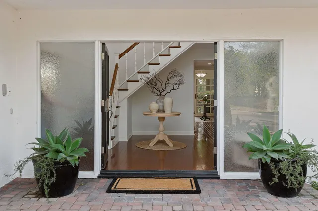 a vase of flowers sitting on a floor