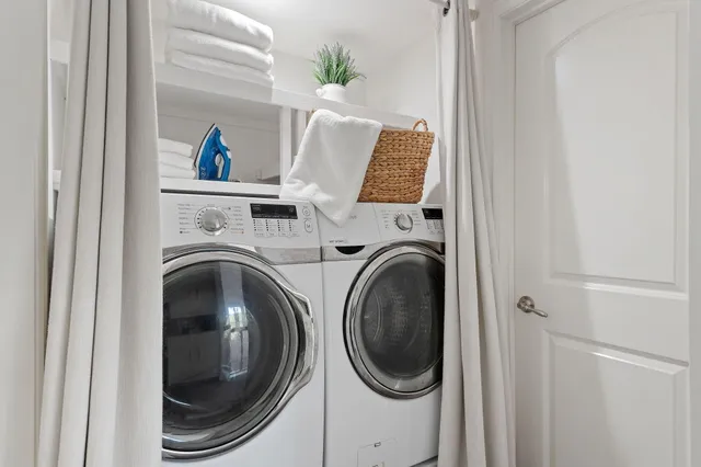 a view of a patio with table and chairs and a barbeque