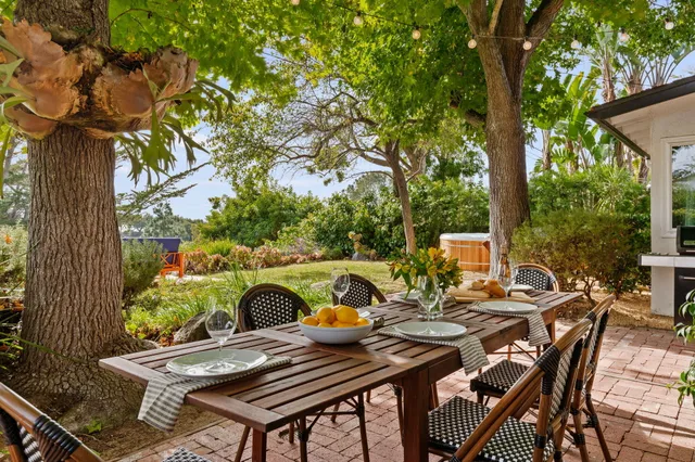 a backyard of a house with yard and outdoor seating