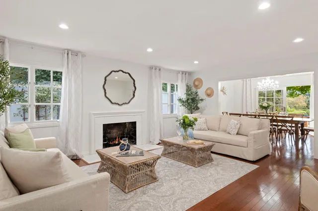 a living room with furniture fireplace and window