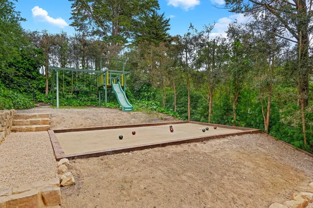 a spacious bedroom with a bed and a chandelier