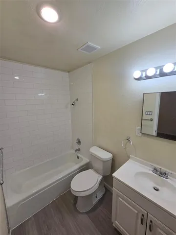 a bathroom with a toilet a sink and bathtub