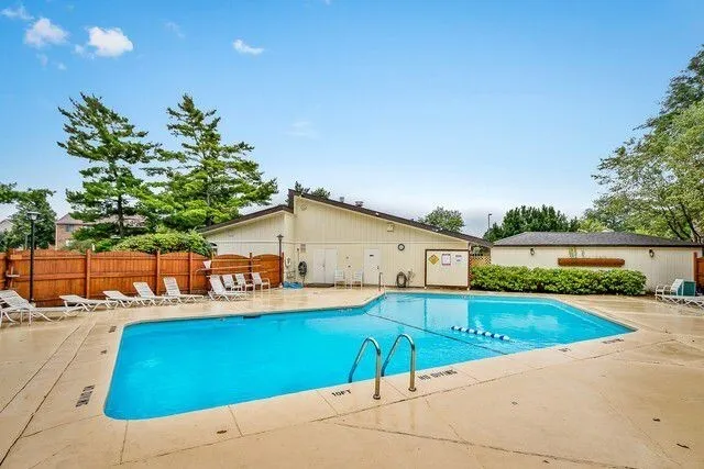 a view of a backyard with a patio and swimming pool