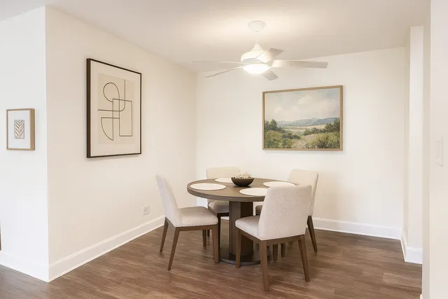 a view of a dining room with furniture and wooden floor