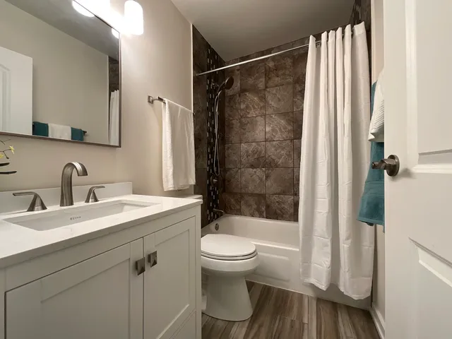a bathroom with a sink toilet and shower