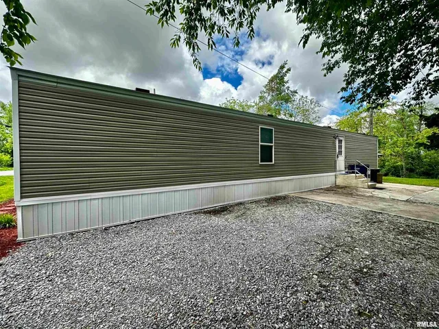 a side view of a house with a yard and garage