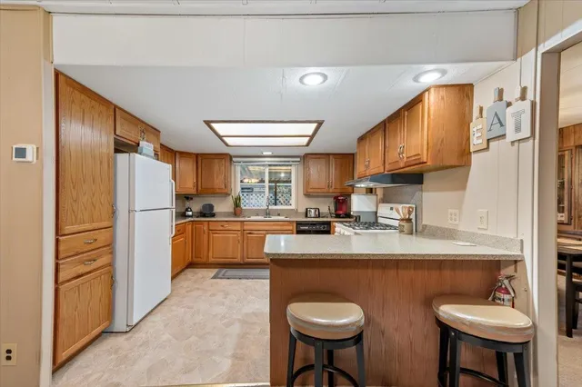 a kitchen with refrigerator a sink and a refrigerator