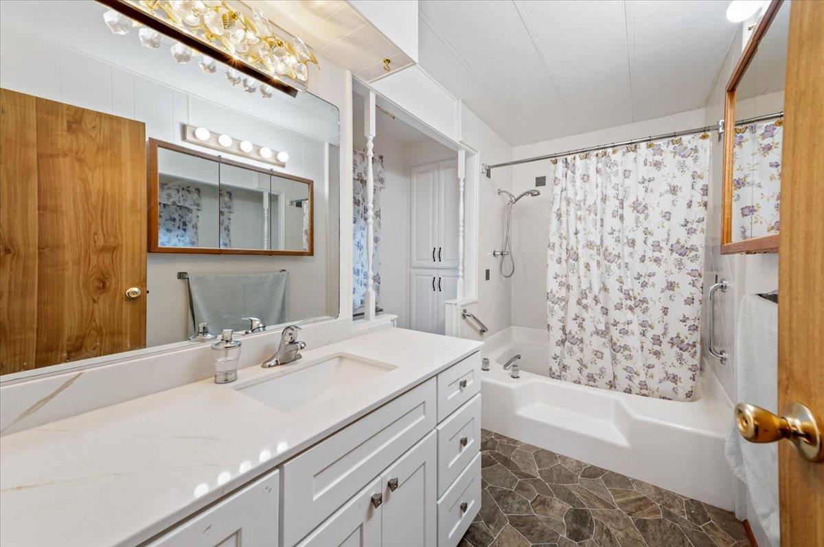 27 Primrose Lane Grass Valley, CA 95945 - Photo 18 of 44 a bathroom with a sink a mirror a bathtub and shower