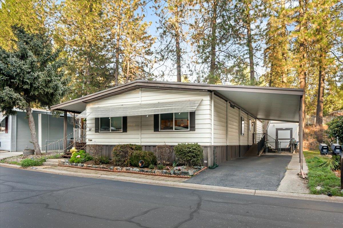 27 Primrose Lane Grass Valley, CA 95945 - Photo 26 of 44 a front view of a house with a yard and potted plants