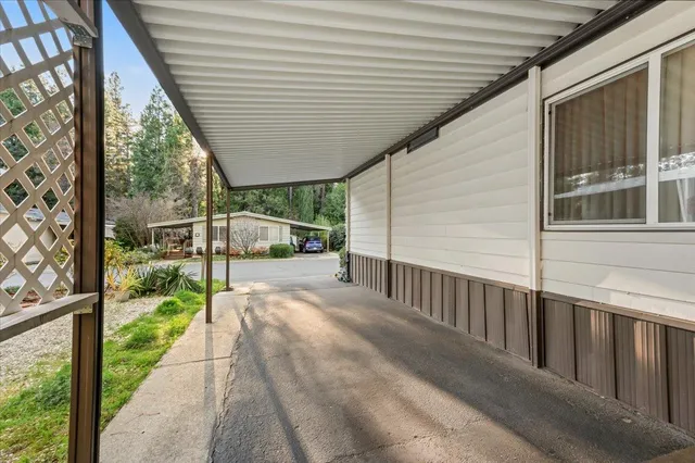 a view of a house with backyard and porch