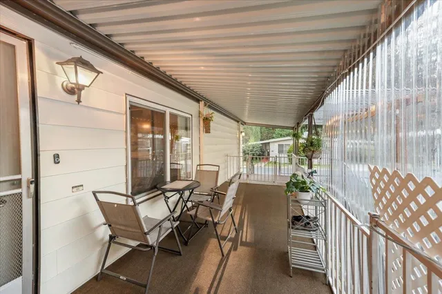 a view of a chairs and table in the balcony