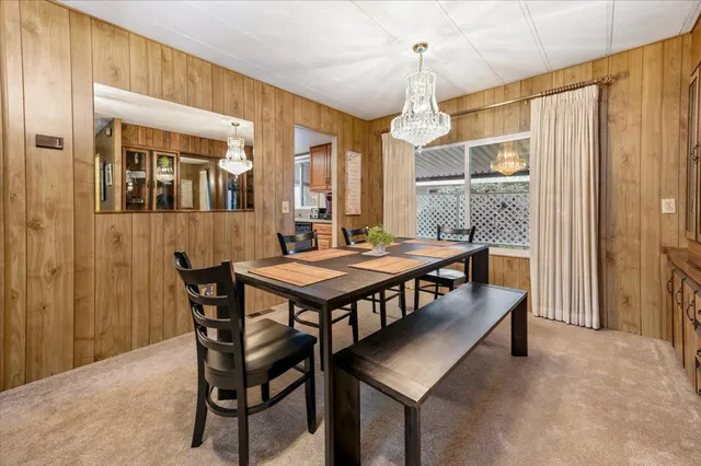 a dining room with a table chairs and a living room