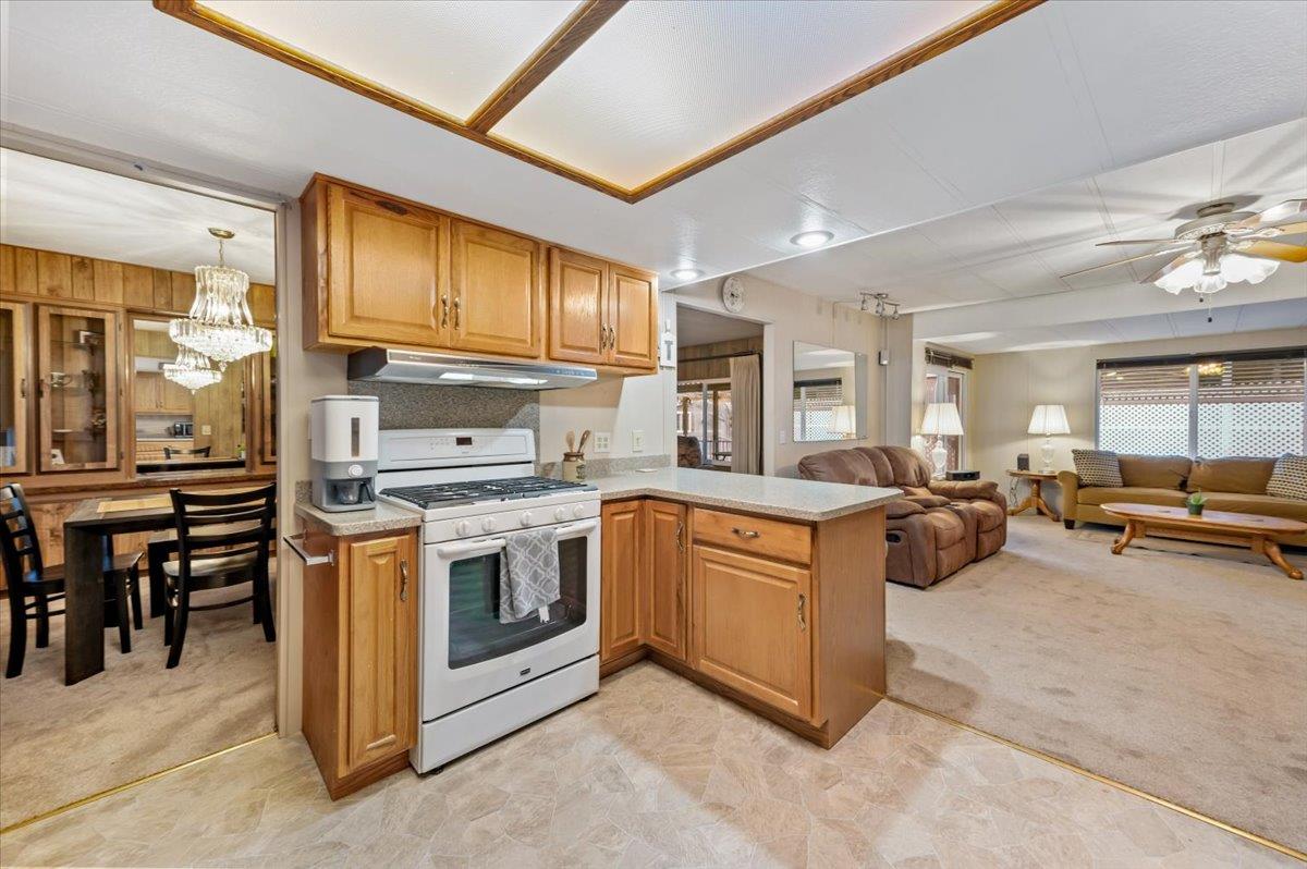 27 Primrose Lane Grass Valley, CA 95945 - Photo 8 of 44 a kitchen with stainless steel appliances granite countertop a stove and a refrigerator