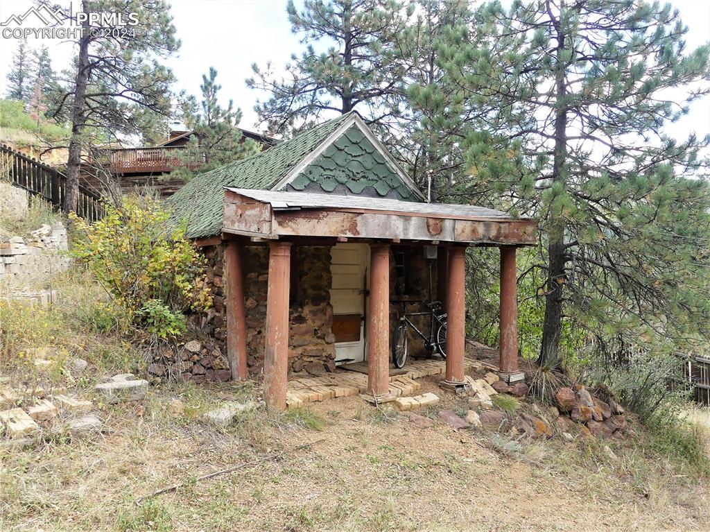 4390 Prairie Street Cascade, CO 80809 - Photo 11 of 18 a backyard of a house with barbeque oven and outdoor seating