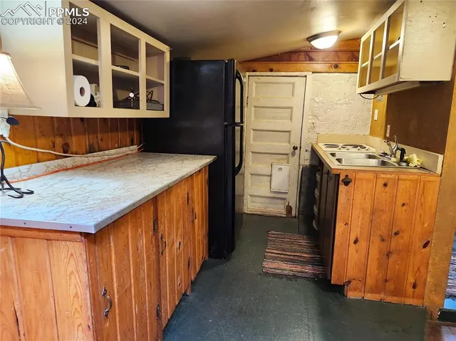 a kitchen with a refrigerator and a stove