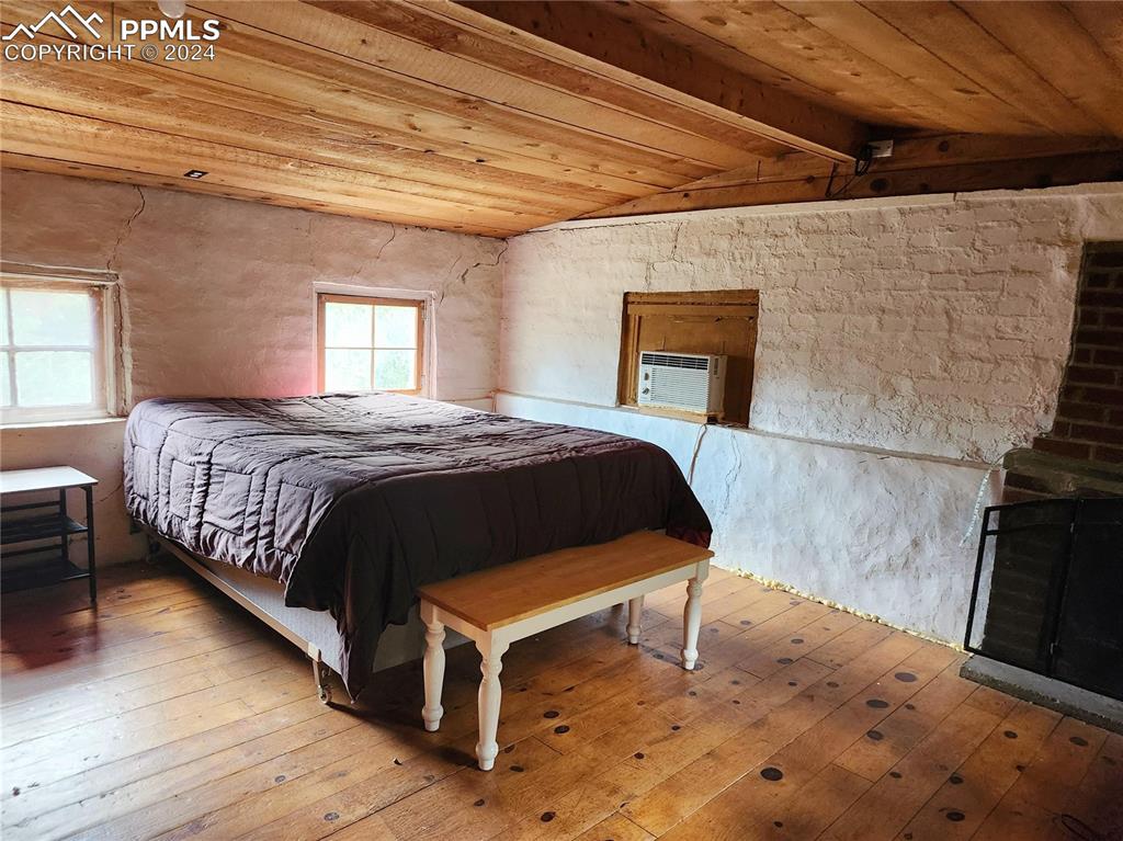 4390 Prairie Street Cascade, CO 80809 - Photo 8 of 18 a bedroom with a bed and window