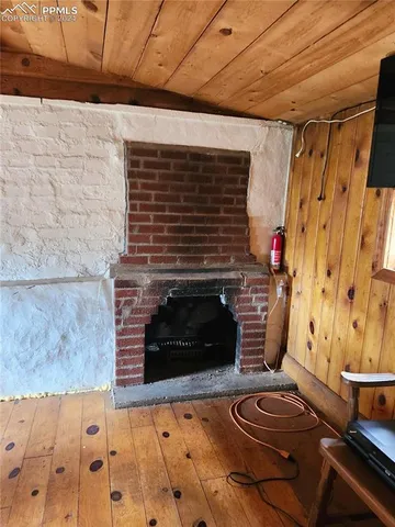 a living room with fireplace and a fireplace