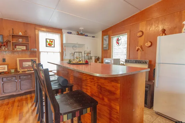 a dining table with chairs and window