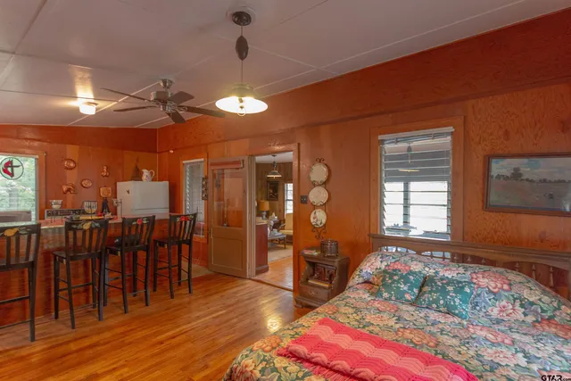 a bedroom with furniture and wooden floor