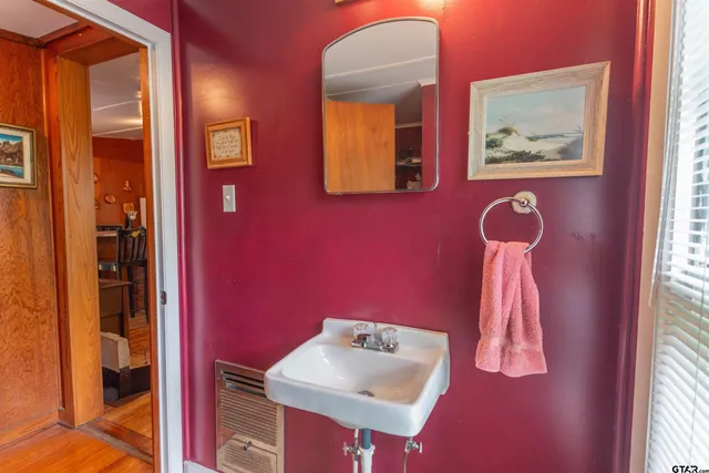 a bathroom with a sink and a mirror