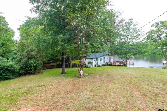 a swimming pool with outdoor seating and yard