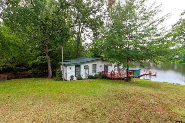 a view of a house with a yard and sitting area