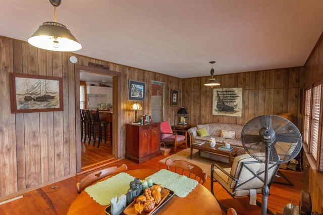 a living room with furniture a lamp and a chandelier
