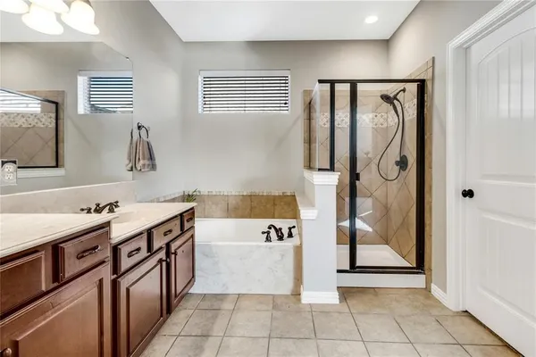 a bathroom with a sink vanity tub and a mirror