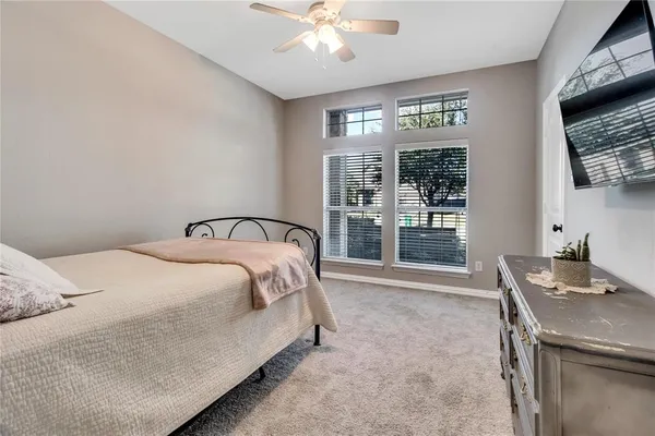 a bedroom with a bed and a television