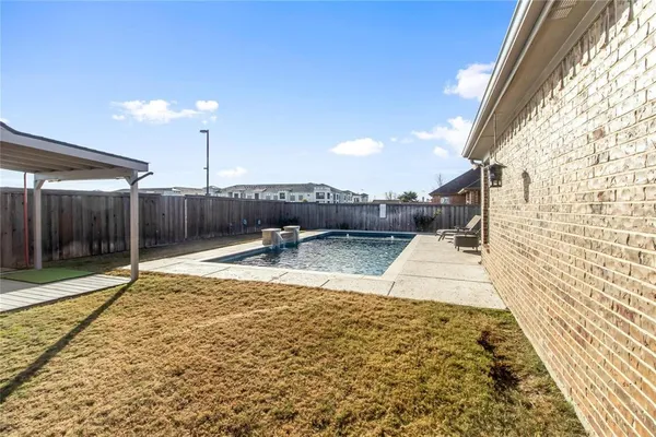 a view of a house with backyard and deck