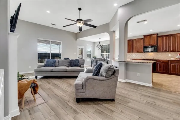 a living room with furniture and a wooden floor