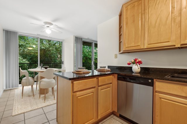 5902 Forest View Road, Unit 2D Lisle, IL 60532 - Photo 6 of 27 a kitchen with stainless steel appliances granite countertop a stove a sink and a microwave