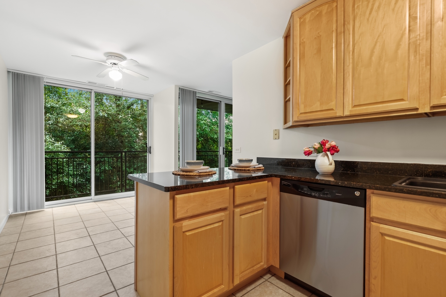 5902 Forest View Road, Unit 2D Lisle, IL 60532 - Photo 7 of 27 a kitchen with stainless steel appliances granite countertop a stove a sink and dishwasher with wooden floor